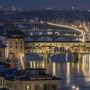 The Ponte Vecchio bridge over the Arno river at dusk in Florence, Italy