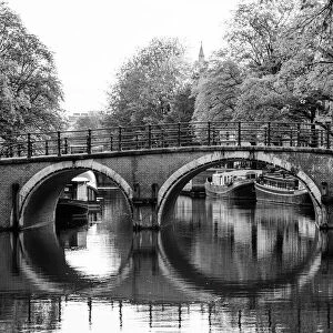 Typical arch bridge in Amsterdam in black and white