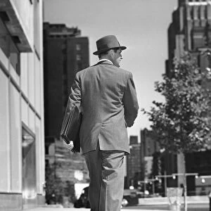 Back view of man walking on street