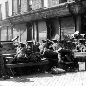 British troops hold a barrier in a Dublin Street during the week long Irish Rebellion of 1916