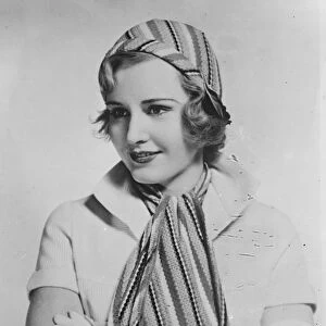 Cap and scarf to match for sports. The latest thing in sportswear worn by Madge