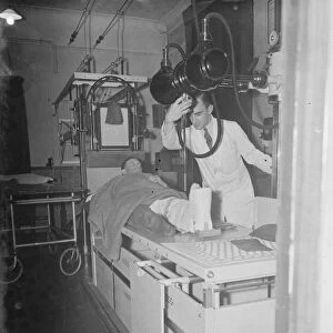 Gravesend Hospital in Kent. The X-ray department. A patient has a scan of his
