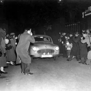 A host of press photographers descend upon the car belonging to Group Captain Peter