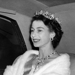 Queen Elizabeth II jewels glittering in her hair and at her throat arrives at Swedish