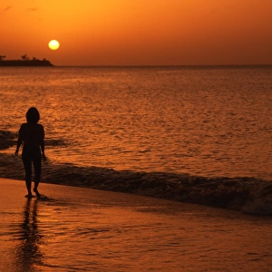 Sunset with girl silhouette, on tropical beach