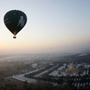 This photo taken on February 5, 2014 shows a hot air balloon flying over a temple