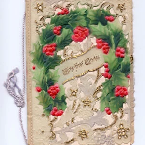 A Christmas card made of plastic with an embossed holly horseshoe, circa 1910 (plastic)