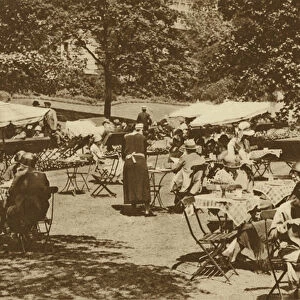 Continental lunch-time scene beneath the trees in the Embankment Gardens at Charing Cross (b / w photo)