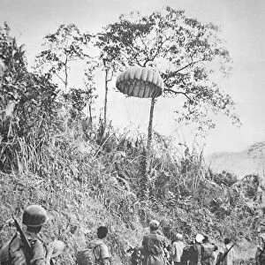 French and Vietnamese soldiers recover supplies parachuted to them