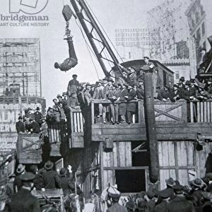 Houdini escaping from a strait-jacket while suspended from a crane in New York City