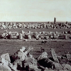 Panorama of the remains of the Temple of Minerva and the Temple of Apollo in Selinunte. There is a man on horseback among the ruins of the archeological site