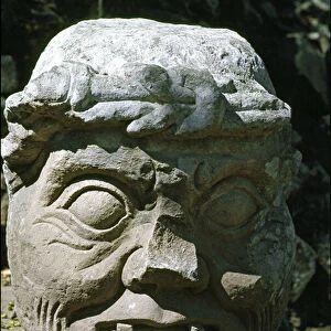 Stone sculpture of a old man head called the old man of Copan, temple 11