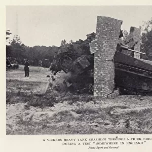 A Vickers heavy tank crashing through a thick brick wall during a test "somewhere in England"(b / w photo)