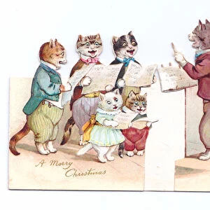 A Victorian die-cut shape Christmas card of cats wearing human clothes holding music