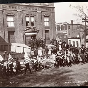 Young boys with flags marching in a parade at Dobbs Ferry, New York