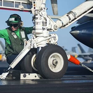 Aviation Boatswains Mate attaches an F / A-18F Super Hornet to the catapult