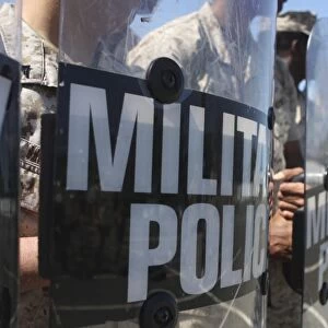 A close-up view of Marines holding riot control shields