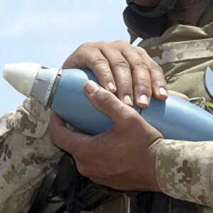 Close-up view of a soldier cradling a munition