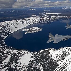 Two F-15 Eagles fly over Crater Lake in Central Oregon