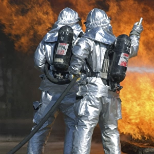 A firefighter fights a fire during a readiness training exercise