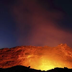 Lava lake illuminating walls of pit crater at night, Erta Ale volcano, Danakil Depression