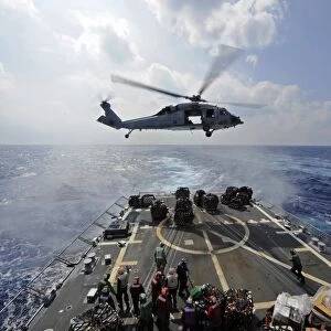 An MH-60R Sea Hawk transfers supplies to the flight deck of USS Wayne E. Meyer