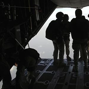 Pararescuemen prepare for a HALO jump aboard an HC-130 over Djibouti