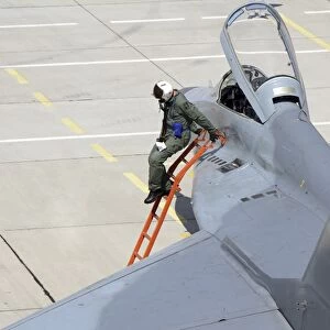Serbian Air Force pilot climbs down from the cockpit of a MiG-29