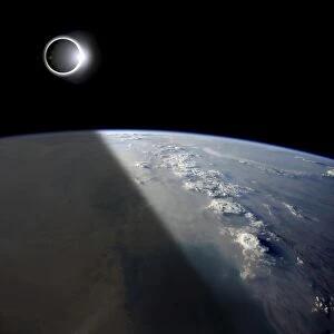 A solar eclipses partially shades the Earth below