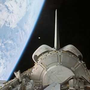 Space Shuttle Discoverys payload bay backdropped by Earths horizon