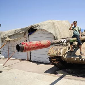 A T-55 tank with two children playing on it in Benghazi, Libya