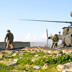 U. S. Army soldiers prepare to fuel an OH-58 Kiowa Warrior