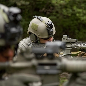 U. S. Special Forces soldiers provide security with automatic rifles