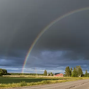 Double rainbow over road through countryside. Nivala, Northern Ostrobothnia, Finland