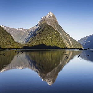 Early morning light on Mitre Peak (1683m) reflected in the calm waters of Milford