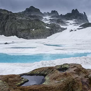 Ice in a mountain lake. Aiguilles Rouges Reserve, Alps, France, July