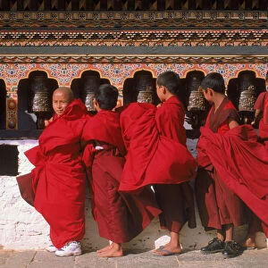 Monks turning prayerwheels. Punakha festival, Bhutan