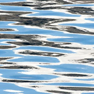 Reflections of clouds in ripples of sea water, Svalbard, Norway, June 2010