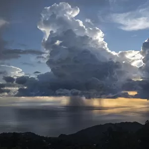Sunset with dramatic rain clouds during hurricane season. Dominica, West Indies