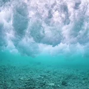 Wave breaking over the rubble zone close to the reef crest of a coral reef. Baa Atoll, Maldives. Indian Ocean