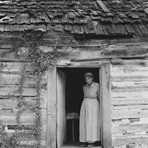 Caroline Atwater standing in the kitchen doorway of... log house, North Carolina, 1939. Creator: Dorothea Lange