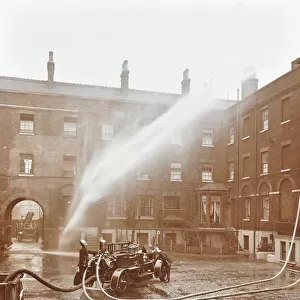 Firemen demonstrating hoses worked by a petrol motor pump, London Fire Brigade Headquarters, 1909