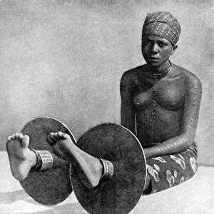 An Igbo woman wearing ankle plates, Nigeria, West Africa, 1922. Artist: Northcote Thomas