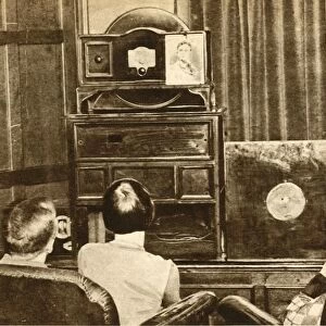 People watching an early television broadcast, c1930, (1933). Creator: Unknown