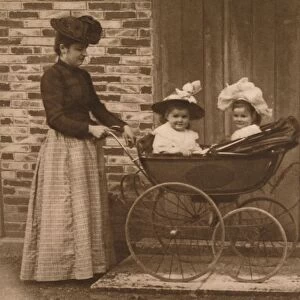 Woman and children in a pushchair, 1937