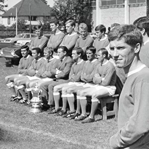 Everton F. C. New signing Alan Ball, stands to one side as last year's F. A. Cup team pose with the Cup for an official group photo shoot 1966