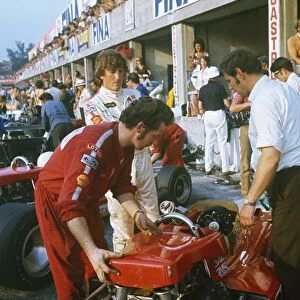1970 Italian Grand Prix: Jochen Rindt, during practice before his fatal accident. Eddie Dennis and chief mechanic, Dick Scammell prepare the car in the pits