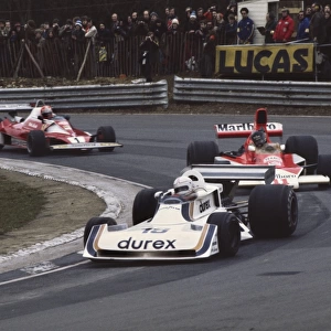 1976 British Grand Prix: Alan Jones, 5th position, leads James Hunt, Disqualified and Niki Lauda, 1st position, action