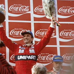 1982 Belgian Grand Prix: John Watson 1st position, with teamate Niki Lauda, 3rd position next to him on the podium