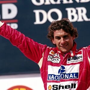 Formula One World Championship: Ayrton Senna McLaren celebrates his second and final home GP victory on the podium